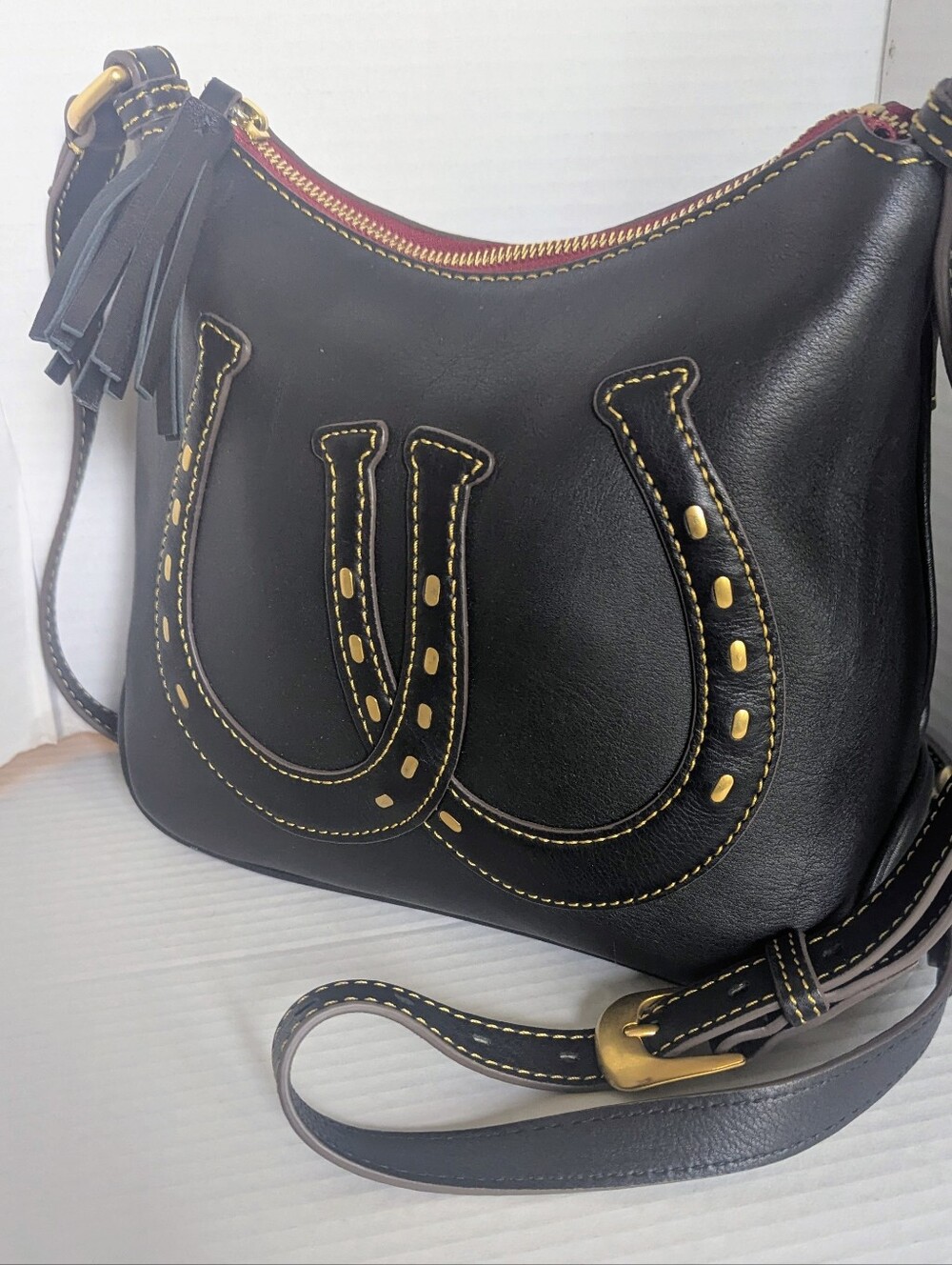 Dooney & Bourke Western Black Leather Hobo with Gold Stitching and Tassel
